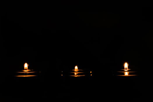 Candle lights in darkness
