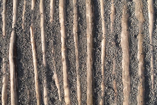 wooden timbers in gravel as texture