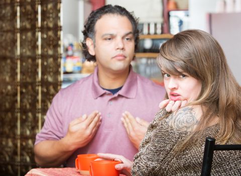 Arguing man and woman in coffee house