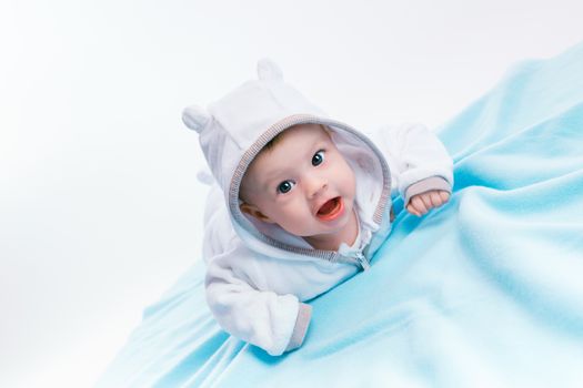 Cute baby in the hood on a blue blanket