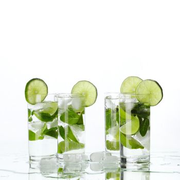 Party mojito cocktails with lime and mint isolated on white background