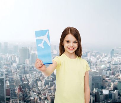 travel, holiday, vacation, childhood and transportation concept - smiling little girl with airplane ticket