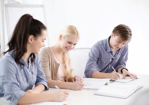 school and education concept - group of smiling students with notebooks at school