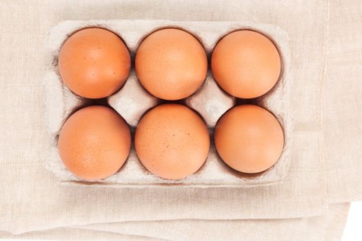 Natural organic chicken eggs in cardboard package, top view. Natural healthy eating. 