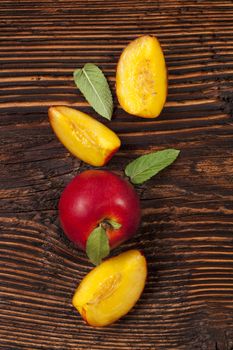 Fresh ripe nectarines background on wooden rustic table. Healthy fresh ripe fruit eating. 