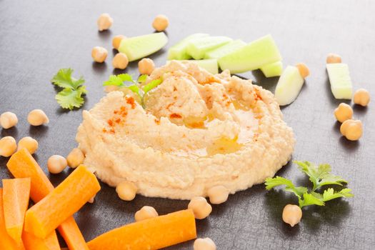 Hummus and fresh vegetables and herbs. Delicious healthy vegan eating. 