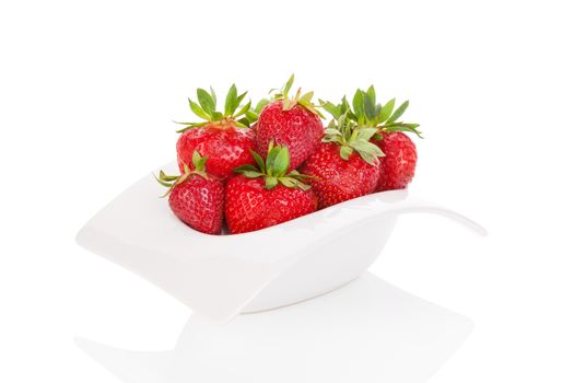 Delicious strawberries in white bowl isolated on white background. Healthy fruit eating. 