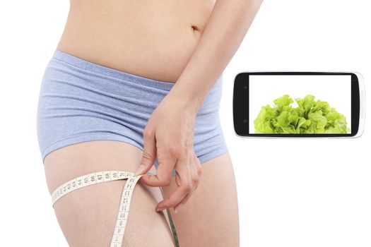 Weightloss and diet in information age. Diet, detox and fitness app on smartphone screen and attractive beautiful woman measuring her body with tape measure. Modern technology and healthy lifestyle. 