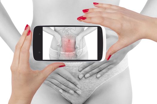 Intestine pain. Modern high tech medicine. Beautiful woman photography isolated on white background seeing her diagnosis on a smartphone screen.