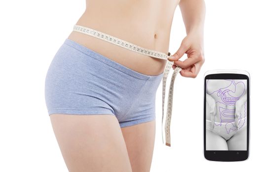 Beautiful caucasian girl measuring her waist with tape measure isolated on white background and weightloss and fitness app on spartphone screen. Healthy living in the information age.