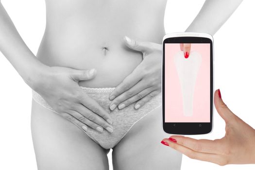 Beautiful woman touching her belly and mobile phone with ovulation cycle app. Menstruation, period, pregnancy in the information age. Feminine body.