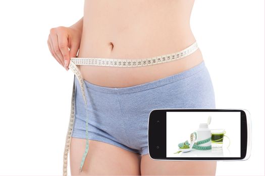 Weightloss and diet in information age. Diet, detox and fitness app on smartphone screen and attractive beautiful woman measuring her body with tape measure. Modern technology and healthy lifestyle. 