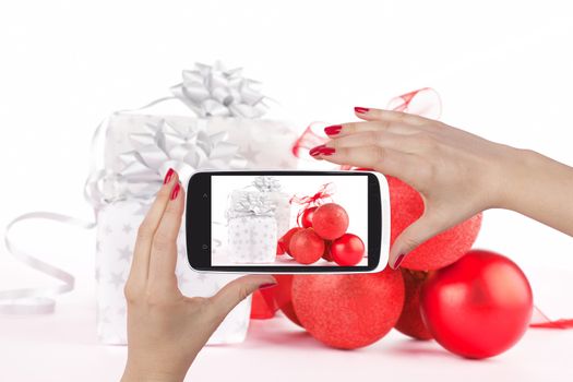 Luxurious christmas background on smartphone screen inf female hands. Sharing on social media.