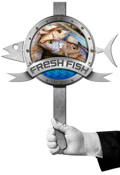 Hand of chef holding a metal sign with fresh fishes, blue waves and metal ribbon with text Fresh fish. Isolated on white background