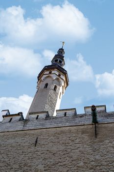 Close up detailed bottom view of medieval Lutheran Church of the Holy Ghost in Tallinn, Estonia, on blue cloudy sky background.