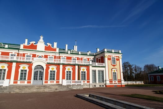 Front view of Kadriorg Palace in Tallinn Estonia, built by Tsar Peter the Great in 1725, on navy blue sky background.