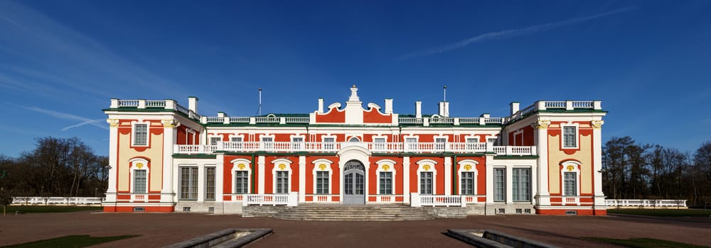 Front view of Kadriorg Palace in Tallinn Estonia, built by Tsar Peter the Great in 1725, on navy blue sky background.