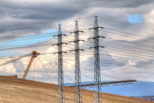 Idyllic industrial landscape - open pit and power line