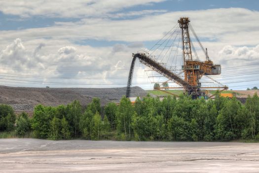 Idyllic industrial landscape - open pit and power line