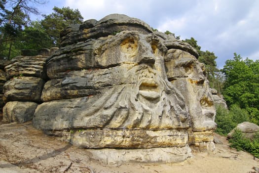 Heads of Devils are about 9 m high rock sculptures of giant heads carved into the sandstone cliffs in the pine forest above the village Zelizy in the district Melnik, Czech republic. It is the work of sculptor Vaclav Levy, who created in the period 1841-1846.