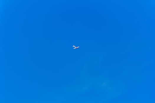 Photo of flying military plane in blue sky