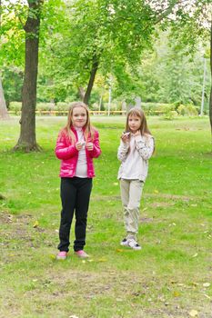 Photo of two eating girls in summer