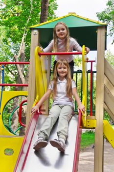 Photo of two active girls on nursery platform