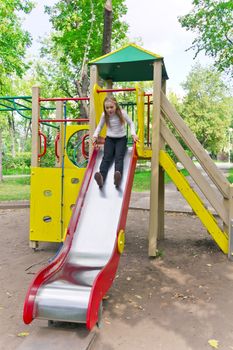 Photo of active girl on nursery platform in summer