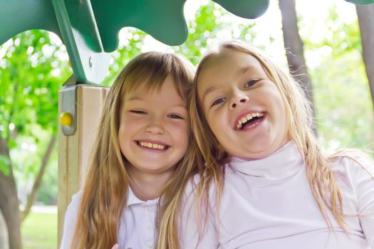 Photo of two smiling girls in summer