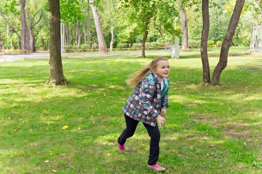 Photo of cute running girl in summer