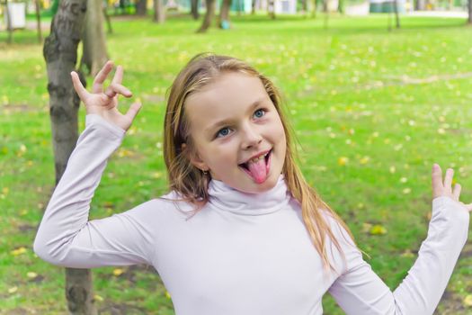 Portrait of cute girl with put out tongue