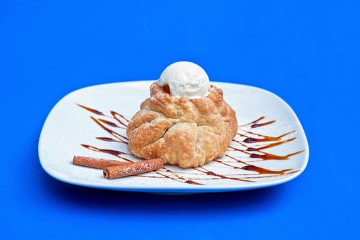 apple strudel with ice cream at blue background