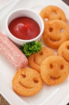sausages with smiling potatoes and tomato sauce