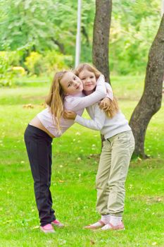 Photo of two embracing girls in summer