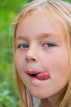 Portrait of cute girl with put out tongue