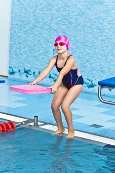 Photo of jumping girl in swimming pool