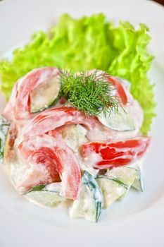 Salad from cucumber tomato and sour cream