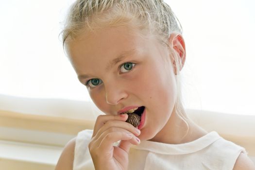 Photo of eating cute girl with blond hair