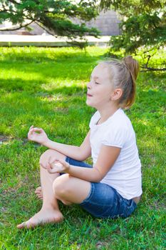 Photo of cute girl in lotus pose