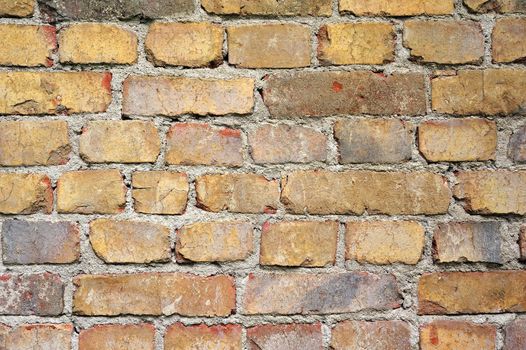 Patterned brick wall with imperfect grout.