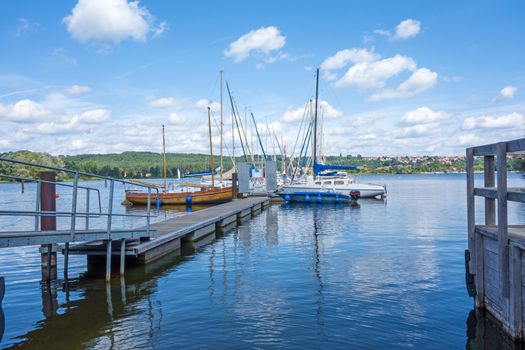 Landing pier at Brombachsee, Bayern, Germany, with sailing boats and ships
