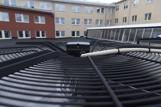 A ventilation fan and some electrical installations on a roof top