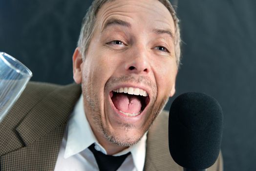 Close-up of a drunken wedding guest making a joke.