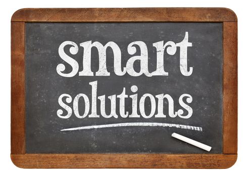 Smart solutions sign - white chalk text on a vintage slate blackboard