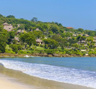 Tropical Jimbaran beach with white sand in Bali, Indonesia