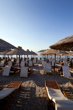  the photographed wooden umbrellas located in the territory of a beach