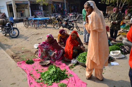 Jodhpur, India - January 2, 2015: Indian people shopping at typical vegetable street market in India on January 2, 2015 in Jodhpur, India. Food hawkers in India are generally unaware of standards of hygiene and cleanliness.