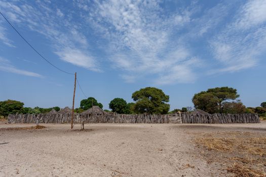 Traditional african village with housed and wooden fence in Namibia, near town Kavango in region with the highest poverty level in Namibia
