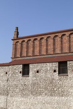 old synagogue with 
stone wall in jewish district of krakow - kazimierz on szeroka street in poland