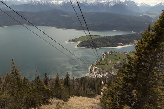 A view from a mountain top with a lake in the background